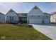 Charming home with white brick, complemented by a three car garage and well-manicured lawn at 4034 Saddle Club S Pkwy, Bargersville, IN 46106