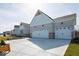 Spacious three car garage with a concrete driveway and stylish exterior design at 4034 Saddle Club S Pkwy, Bargersville, IN 46106