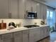 Kitchen boasts gray cabinets, white countertops, and stainless steel microwave and cooktop at 4034 Saddle Club S Pkwy, Bargersville, IN 46106