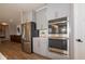 The kitchen features stainless steel appliances, gray cabinets, and a view of the stairs at 4034 Saddle Club S Pkwy, Bargersville, IN 46106