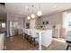 Modern kitchen with stainless steel appliances, island seating, and pendant lighting at 4034 Saddle Club S Pkwy, Bargersville, IN 46106