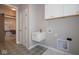 Laundry room with decorative flooring, built-in cabinets, and a utility sink at 4034 Saddle Club S Pkwy, Bargersville, IN 46106