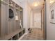 Mud room features built-in storage cubbies, decorative tile flooring, and a utility sink at 4034 Saddle Club S Pkwy, Bargersville, IN 46106