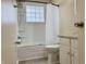 Well-lit bathroom showcasing a shower with a glass block window and white vanity at 4151 Bowman Ave, Indianapolis, IN 46227