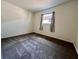 Cozy bedroom featuring neutral walls, soft carpet, and a bright window with natural light at 4151 Bowman Ave, Indianapolis, IN 46227
