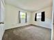 Bright bedroom with two windows, neutral walls, and plush carpet at 4151 Bowman Ave, Indianapolis, IN 46227