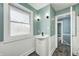 Updated bathroom showcasing a modern vanity and a bright window at 420 N Irvington Ave, Indianapolis, IN 46219