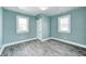 Bright bedroom with new flooring, two windows, and a closet creating an inviting and comfortable living space at 420 N Irvington Ave, Indianapolis, IN 46219