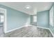 Cozy bedroom with light blue walls, wood-look floors, and a bright window at 420 N Irvington Ave, Indianapolis, IN 46219