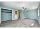 Bright bedroom with hardwood-style flooring, updated lighting, and closet at 420 N Irvington Ave, Indianapolis, IN 46219