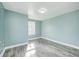 Light-filled bedroom with wood-look floors and fresh paint at 420 N Irvington Ave, Indianapolis, IN 46219