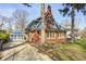 Well-maintained home with a classic architectural style, featuring a detached garage and mature trees at 420 N Irvington Ave, Indianapolis, IN 46219