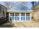 Detached two-car garage with classic carriage-style doors and a blue and white painted exterior at 420 N Irvington Ave, Indianapolis, IN 46219