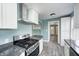 Updated kitchen featuring new stainless steel gas range and granite countertops at 420 N Irvington Ave, Indianapolis, IN 46219