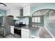 Eat-in kitchen featuring stainless steel appliances and an archway to the living room at 420 N Irvington Ave, Indianapolis, IN 46219