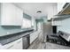 Updated kitchen featuring stainless steel appliances, granite countertops, and white cabinets at 420 N Irvington Ave, Indianapolis, IN 46219