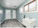 This spacious laundry room offers great natural light, new flooring, and access to storage and the main house at 420 N Irvington Ave, Indianapolis, IN 46219