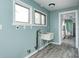 Bright laundry room with large sink and updated flooring, perfect for modern living and convenience at 420 N Irvington Ave, Indianapolis, IN 46219
