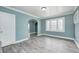 Bright living room featuring an archway, large window, light gray floors, and light blue walls at 420 N Irvington Ave, Indianapolis, IN 46219
