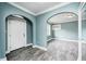 Bright, airy living room showcasing gray floors, an arched doorway, and white trim at 420 N Irvington Ave, Indianapolis, IN 46219