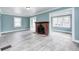Spacious living room featuring gray floors, a fireplace, and abundant natural light at 420 N Irvington Ave, Indianapolis, IN 46219