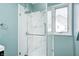 The modern glass enclosed shower adds a touch of luxury to this bathroom, with its marble and window view at 420 N Irvington Ave, Indianapolis, IN 46219