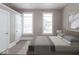 Neutral bedroom with a modern bed frame, two large windows, and ample closet space at 430 Parkway Ave, Indianapolis, IN 46225