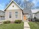 Charming home featuring a neat front yard and a brightly colored front door at 430 Parkway Ave, Indianapolis, IN 46225