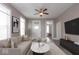 Cozy living room with neutral tones, a ceiling fan, and plenty of natural light at 430 Parkway Ave, Indianapolis, IN 46225