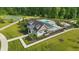 Stunning aerial view of community pool, sports court and clubhouse surrounded by lush landscaping at 5130 Melbourne Pl, Zionsville, IN 46077