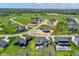 Panoramic aerial shot of the neighborhood highlighting the house with a patio area and manicured green spaces at 5130 Melbourne Pl, Zionsville, IN 46077