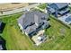 Bird's eye view emphasizes the elegant exterior, long driveway, and verdant landscaping surrounding the property at 5130 Melbourne Pl, Zionsville, IN 46077