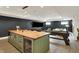 Spacious basement with a wet bar, stainless steel appliances, shuffleboard table, and entertainment area at 5130 Melbourne Pl, Zionsville, IN 46077
