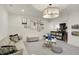 Spacious finished basement area featuring neutral carpet, comfortable seating, and unique wall art at 5130 Melbourne Pl, Zionsville, IN 46077