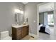 Bathroom featuring a vanity with marble countertop, a toilet, and view to the bedroom at 5130 Melbourne Pl, Zionsville, IN 46077