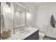 Bathroom features a gray vanity with white countertops, modern fixtures, and decorative floor tiles at 5130 Melbourne Pl, Zionsville, IN 46077
