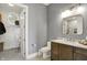 Bathroom featuring a vanity with marble countertop, a toilet, and walk in closet with decor at 5130 Melbourne Pl, Zionsville, IN 46077