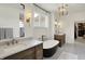 This bright bathroom boasts dual vanities, a freestanding tub, and bronze hardware at 5130 Melbourne Pl, Zionsville, IN 46077
