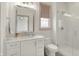 This bathroom has a mosaic tile wall, a glass shower and a white vanity with marble countertop at 5130 Melbourne Pl, Zionsville, IN 46077