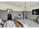 This bedroom has modern lighting and a shelving unit for storage at 5130 Melbourne Pl, Zionsville, IN 46077