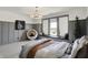 This bedroom has board and batten walls, a window seat and modern lighting at 5130 Melbourne Pl, Zionsville, IN 46077