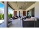 Inviting covered patio with cozy seating, fireplace, and outdoor lighting at 5130 Melbourne Pl, Zionsville, IN 46077