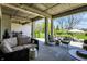 Inviting covered patio with comfortable seating and string lights overlooking the well-manicured backyard at 5130 Melbourne Pl, Zionsville, IN 46077