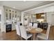 Dining area with seamless flow into kitchen, featuring wet bar, and modern lighting at 5130 Melbourne Pl, Zionsville, IN 46077