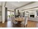 Elegant dining area featuring hardwood floors, ample natural light, and a view into the living room at 5130 Melbourne Pl, Zionsville, IN 46077