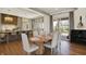 Bright dining area with seamless flow into kitchen area, hardwood floors, and modern decor at 5130 Melbourne Pl, Zionsville, IN 46077