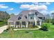 Elegant two-story home boasts a manicured lawn and charming architectural details for curb appeal at 5130 Melbourne Pl, Zionsville, IN 46077