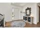 Inviting foyer features hardwood floors, stylish console table, and ample natural light at 5130 Melbourne Pl, Zionsville, IN 46077