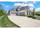 Spacious three-car garage with a long driveway provides ample parking and complements the home's architecture at 5130 Melbourne Pl, Zionsville, IN 46077