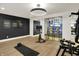 Home gym with workout equipment, motivational art, and a glass-enclosed bar at 5130 Melbourne Pl, Zionsville, IN 46077